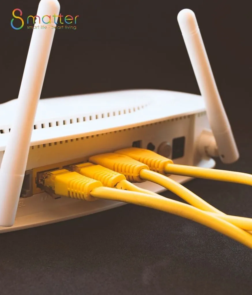 Bộ phát Wifi màu trắng với sợi dây mạng màu vàng cắm vào