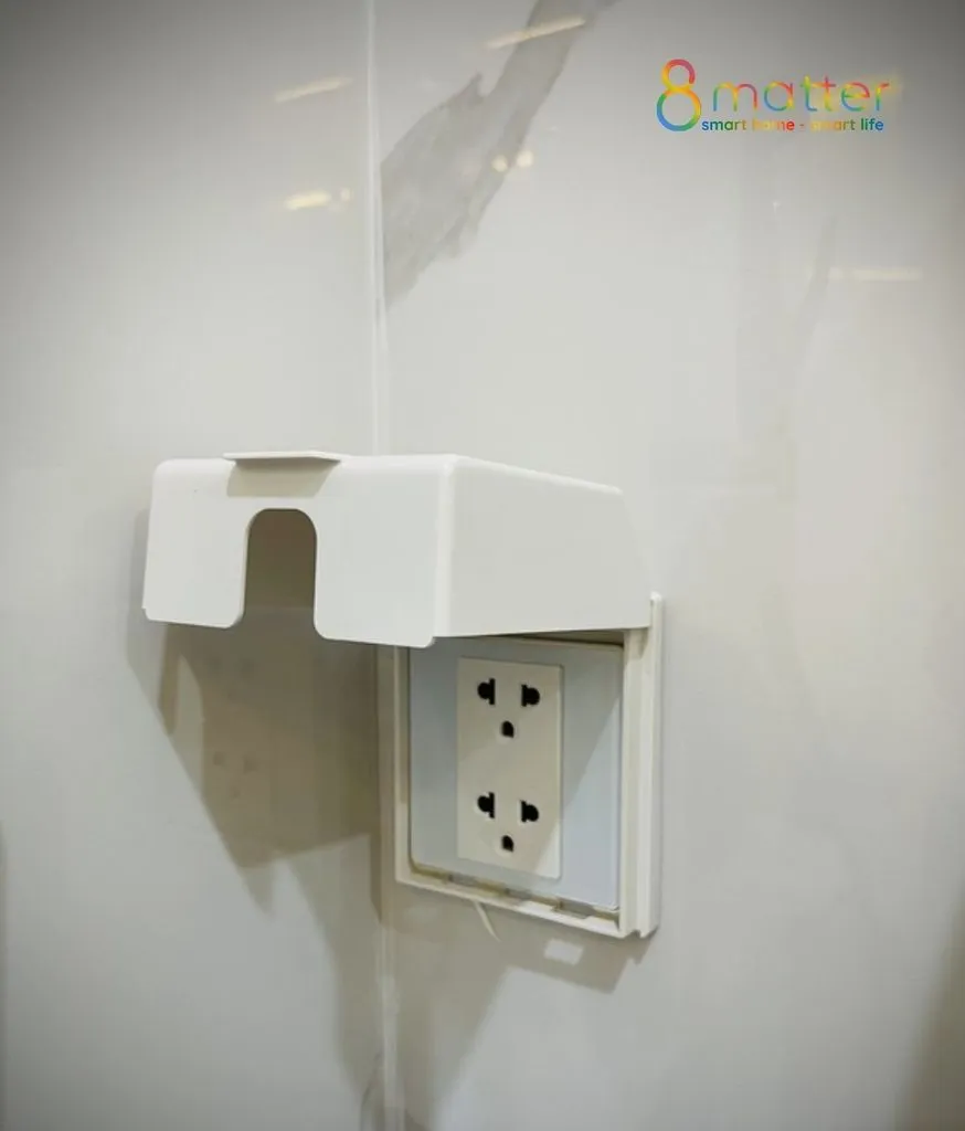Ổ cắm âm tường trắng có nắp che nhựa bảo vệ gắn trên tường đang thi