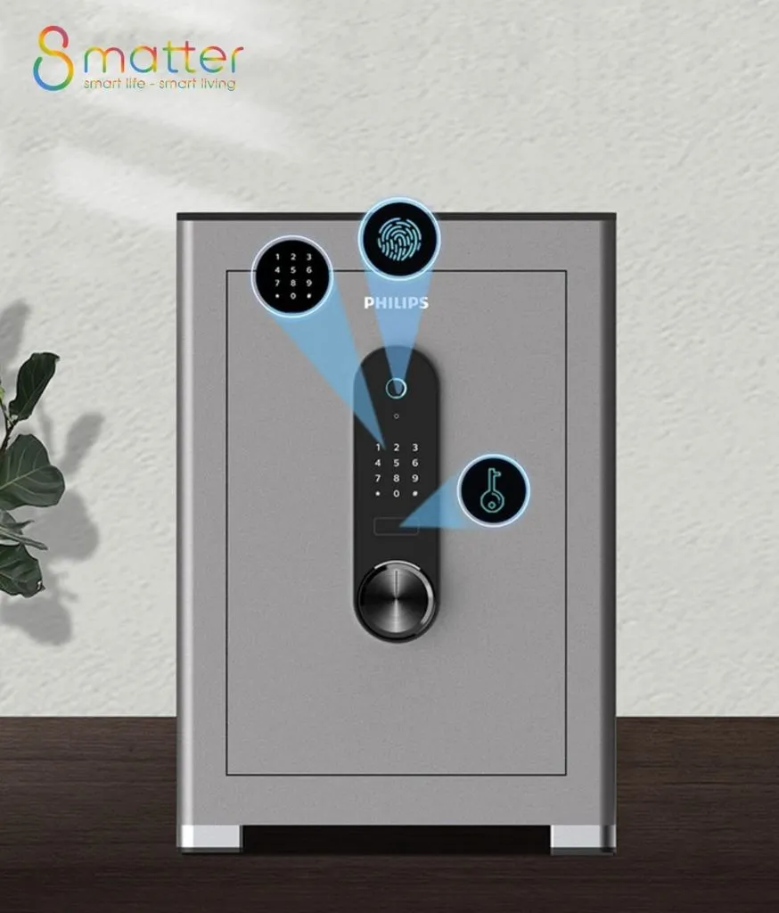 Đồ hoạ két sắt xám đặt cạnh cây cảnh, ba icon xanh chỉ vào bàn phím và núm vặn